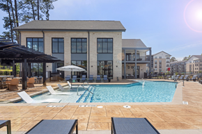 Cary apartment for rent - A large building with a pool in front of it.