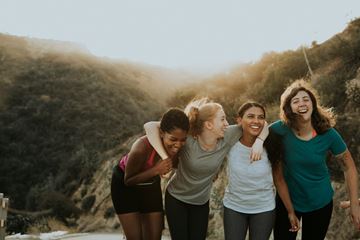 Farmington apartment for rent - Four women are walking together on a path with a hill in the background.