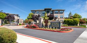 Rohnert Park apartment for rent - The image shows a beautiful entrance to Fiori Estates with a sign and a well-maintained garden.