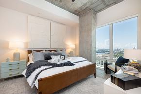 Tampa apartment for rent - a bedroom with a bed and a large window