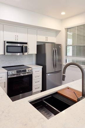 San Ramon apartment for rent - A modern kitchen with a stainless steel refrigerator, microwave, and oven.