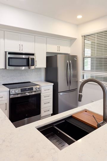 San Ramon apartment for rent - A modern kitchen with a stainless steel refrigerator, microwave, and oven.