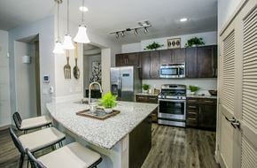 Las Vegas apartment for rent - A modern kitchen with a granite countertop and stainless steel appliances.