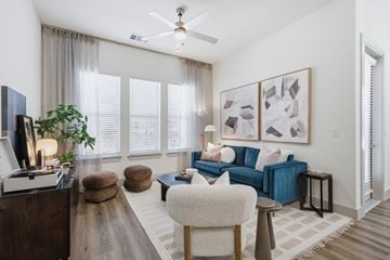 Garland apartment for rent - A living room with a blue couch and a painting on the wall.