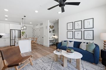 Benbrook apartment for rent - A modern living room with a blue couch and a wooden chair.