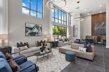 Gilbert apartment for rent - A modern living room with a large window and a painting on the wall.