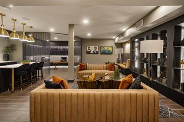 Goodyear apartment for rent - A modern living room with a large sofa and a dining table.