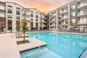Gilbert apartment for rent - A large swimming pool in front of apartment buildings.