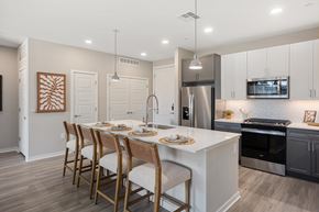 Chandler apartment for rent - A modern kitchen with a dining table set for four.