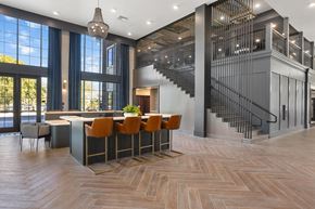 Chandler apartment for rent - A modern kitchen with a bar and a staircase.