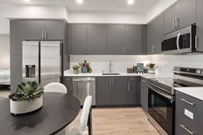 Fontana apartment for rent - A modern kitchen with a black table and grey cabinets.