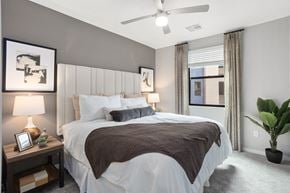 Goodyear apartment for rent - A bedroom with a large bed and a ceiling fan.