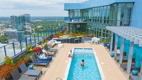 Charlotte apartment for rent - a swimming pool on the top of a building with people in it