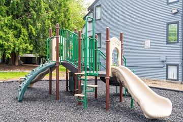 Kent apartment for rent - A playground with a green slide and a brown slide.