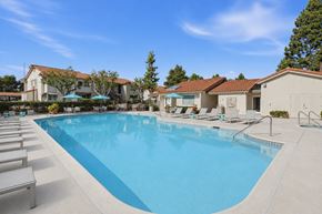 La Mesa apartment for rent - A resort style swimming pool with lounge chairs and umbrellas.