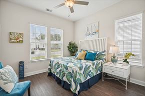 Myrtle Beach apartment for rent - a bedroom with a bed and a ceiling fan