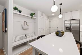 Charlotte apartment for rent - A white kitchen with a table and chairs.