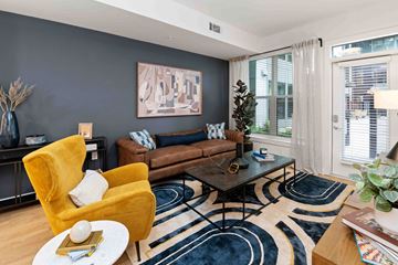 Charlotte apartment for rent - A living room with a yellow chair and a brown couch.