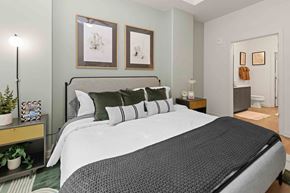 Charlotte apartment for rent - A bedroom with a large bed and two pictures on the wall.