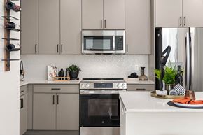 Phoenix apartment for rent - A modern kitchen with a black oven and a black microwave above it.