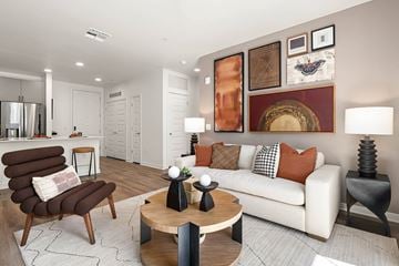Phoenix apartment for rent - A modern living room with a brown chair and a white couch.