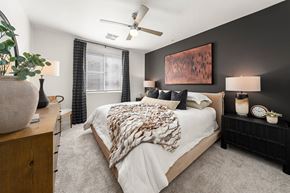 Phoenix apartment for rent - A bedroom with a large bed and a ceiling fan.