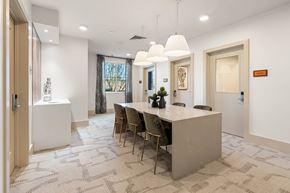 Phoenix apartment for rent - A modern dining room with a long table and chairs.