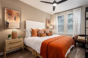 Nashville apartment for rent - A bedroom with a bed, nightstand, and a painting on the wall.
