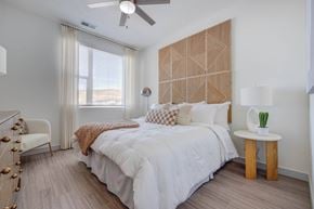 Salt Lake City apartment for rent - A bedroom with a large bed and a wooden headboard.