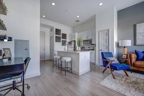 Salt Lake City apartment for rent - A modern kitchen with a blue chair and a white island.