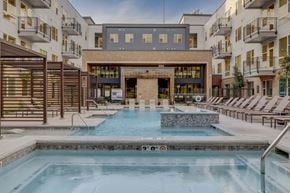 Salt Lake City apartment for rent - A large indoor swimming pool with a waterfall feature in the middle.