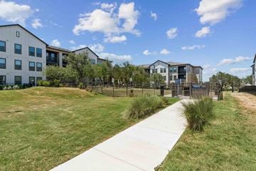 San Antonio apartment for rent - A modern building complex with a walkway in front.