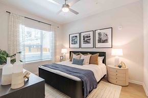 Longwood apartment for rent - A bedroom with a bed, nightstand, and a ceiling fan.