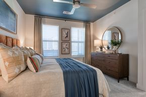San Antonio apartment for rent - A bedroom with a large bed and a ceiling fan.