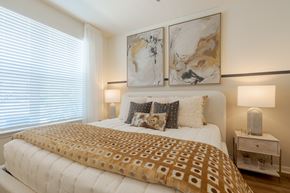 Land O'lakes apartment for rent - A bed with a white comforter and a brown patterned duvet cover.