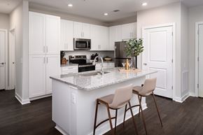 Fairburn apartment for rent - A kitchen with white cabinets and a granite countertop.