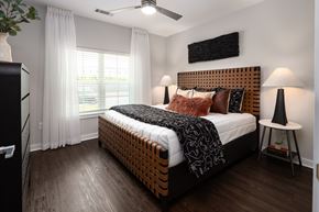 Fairburn apartment for rent - A bedroom with a large bed and a ceiling fan.