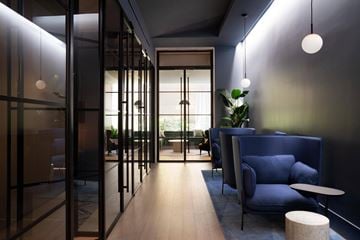 New York apartment for rent - A modern living room with a blue sofa and a glass door.