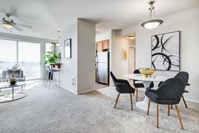 Tacoma apartment for rent - a living and dining area with a white table and black and white chairs