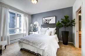 Tacoma apartment for rent - a bedroom with a large bed and a large window