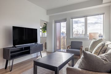 Seattle apartment for rent - A living room with a television and a chair.