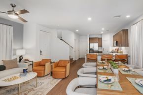 Mckinney apartment for rent - A modern dining room with a table set for a meal.
