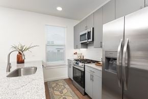 Leander apartment for rent - A kitchen with a stainless steel refrigerator, oven, and sink.