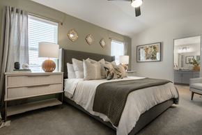 Leander apartment for rent - A bedroom with a large bed and a nightstand with a lamp.