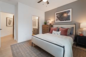 Charlottesville apartment for rent - A bedroom with a large bed and a ceiling fan.