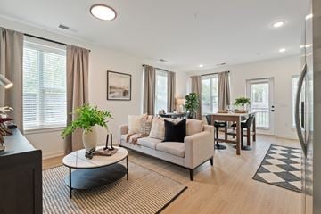 Charlottesville apartment for rent - A modern living room with a white sofa and a coffee table.