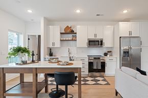 Charlottesville apartment for rent - A modern kitchen with white cabinets and stainless steel appliances.