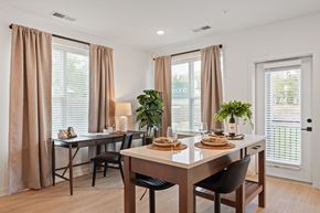 Charlottesville apartment for rent - A dining room with a table set for two and a potted plant on the table.