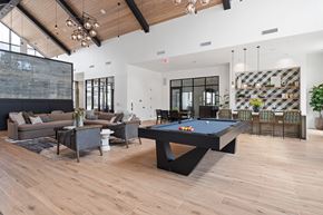 Charlottesville apartment for rent - A pool table is in the middle of a room with a couch and a chair.