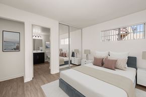 Carlsbad apartment for rent - A bedroom with a large bed and a painting on the wall.